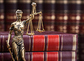 Golden Lady Justice Near Wooden Gavel Over Law Book