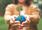 Earth globe ball with growing tree in woman hand, save clean planet, ecology concept