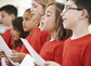 Group Of School Children Singing In Choir Together