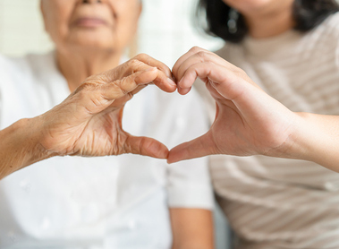 Young and senior woman doing heart sign by their hands togetherness concept. Elderly care and protection with love from grandchild.