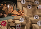 Overturned glass jar full with gingerbread Christmas cookies surrounded by numbered paper bags, a selfmade advent calendar.