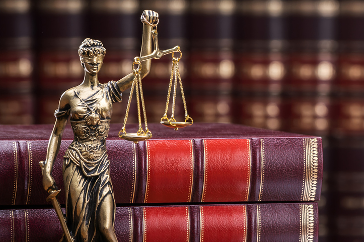 Golden Lady Justice Near Wooden Gavel Over Law Book