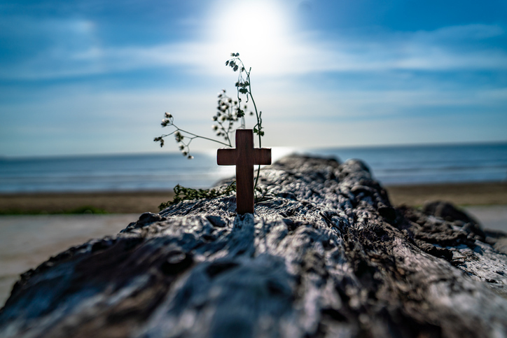 The wooden cross on the beach