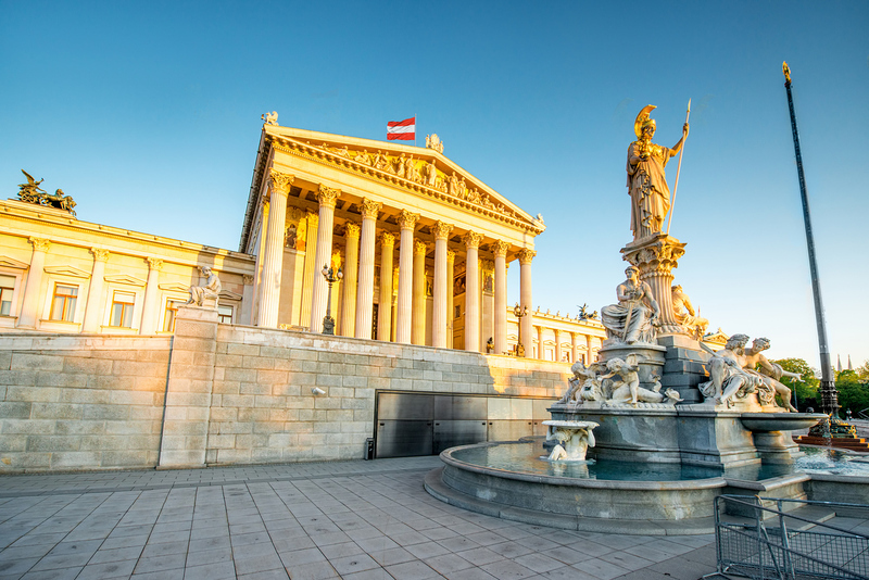 Austrian parliament building with Athena statue on the front in Vienna on the sunrise